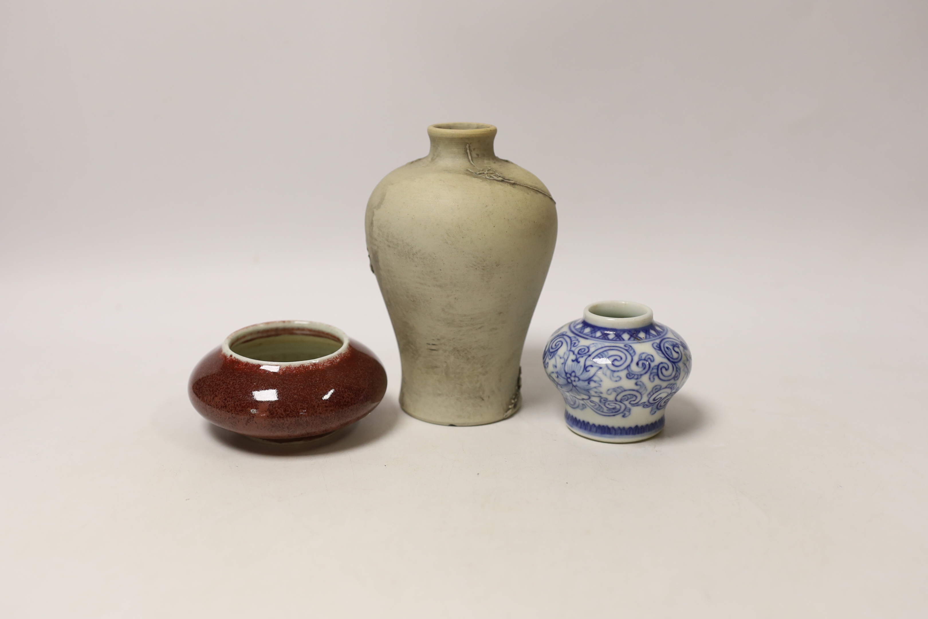 A Chinese sang de boeuf brush washer, a miniature blue and white vase and another vase, largest 14cm high